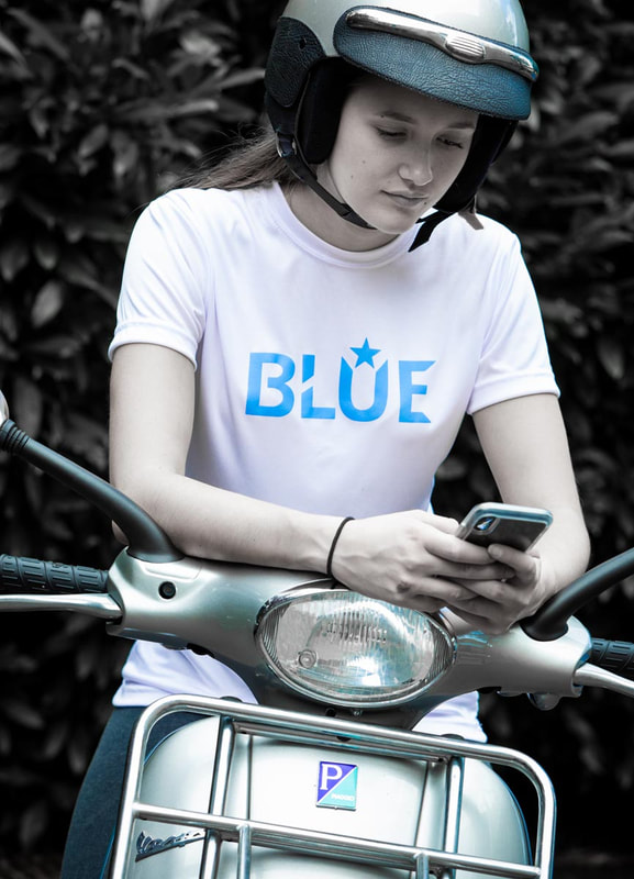 Woman in BLUE Brand T-Shirt on Motor Scooter